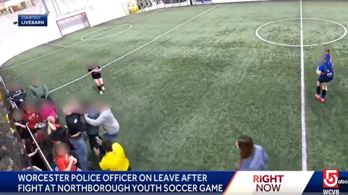 A police officer is on leave and under investigation after he’s accused of attacking a coach at a children’s soccer game in Massachusetts, authorities say.
