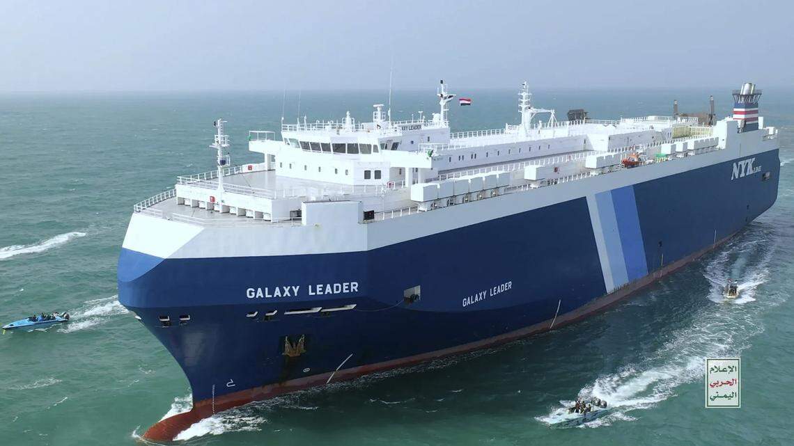 This photo released by the Houthi Media Center shows Houthi escort the cargo ship Galaxy Leader on Sunday, Nov. 19, 2023. Yemen’s Houthis have seized the ship in the Red Sea off the coast of Yemen after threatening to seize all vessels owned by Israeli companies. (Houthi Media Center via AP)