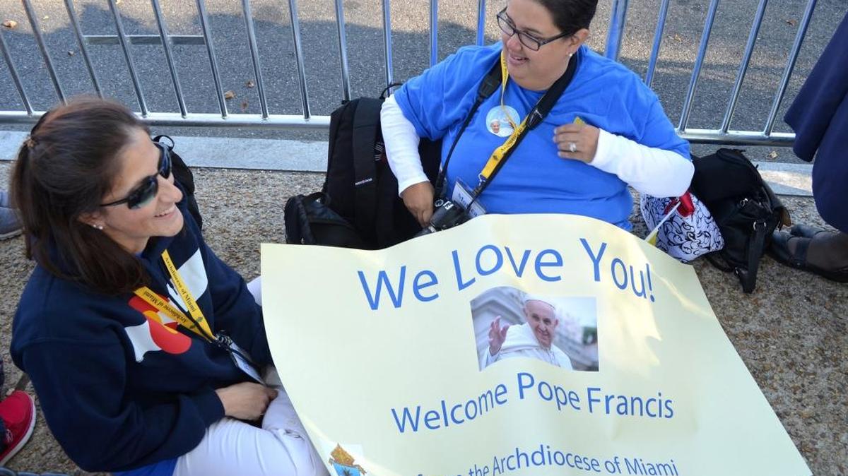 
Teresita Gonzalez and Monica Lauzurique prepare for the arrival of Pope Francis in Washington, D.C., on Sept. 23, 2015. Both were part of a group, organized by the Archdiocese of Miami, that rode a bus through the night to be in position for the pope's visit. 
