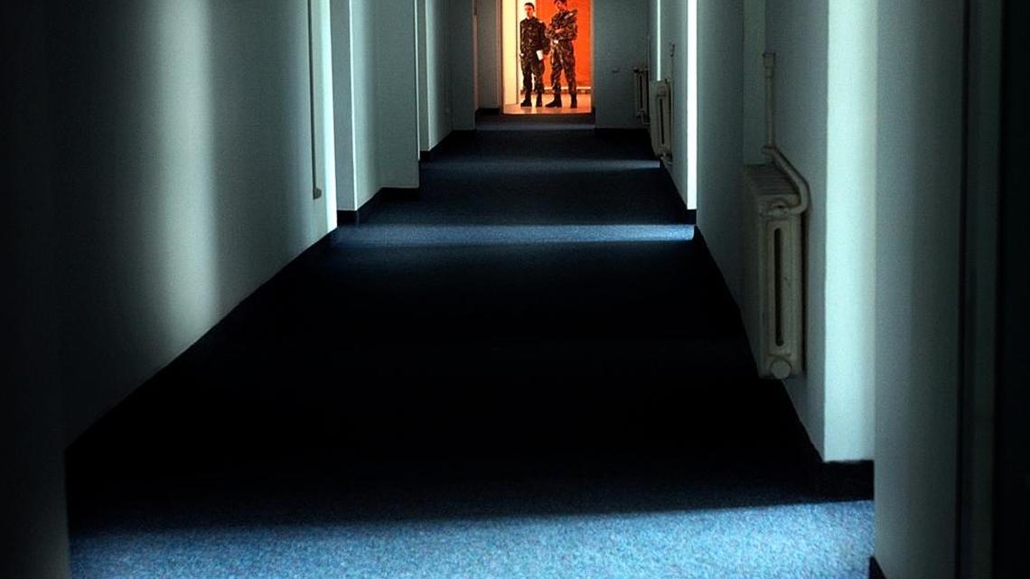 In this Nov. 9, 2005 file photo, Romanian military staff stand at the end of a corridor on the Mihail Kogalniceanu airbase, near the Black Sea port of Constanta, a Soviet-era facility which became a key focus of a European investigation into allegations that the CIA operated secret prisons, some 155 miles east of Bucharest, Romania. The CIA paid Romania “millions of dollars” to host secret prisons, a rights lawyer said Wednesday as the European Court of Human Rights heard accusations that Romania allowed the agency to torture terrorism suspects in a secret renditions program under President George W. Bush.