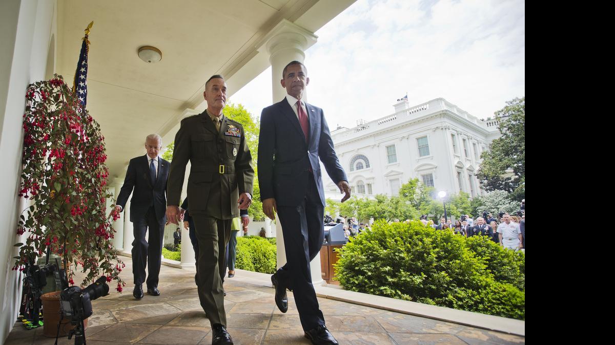 
President Barack Obama walks with Marine Gen. Joseph Dunford Jr., his nominee to be the next chairman of the Joint Chiefs of Staff, after speaking in the Rose Garden of the White House in Washington, Tuesday, May 5, 2015. Walking behind them is Vice President Joe Biden.
