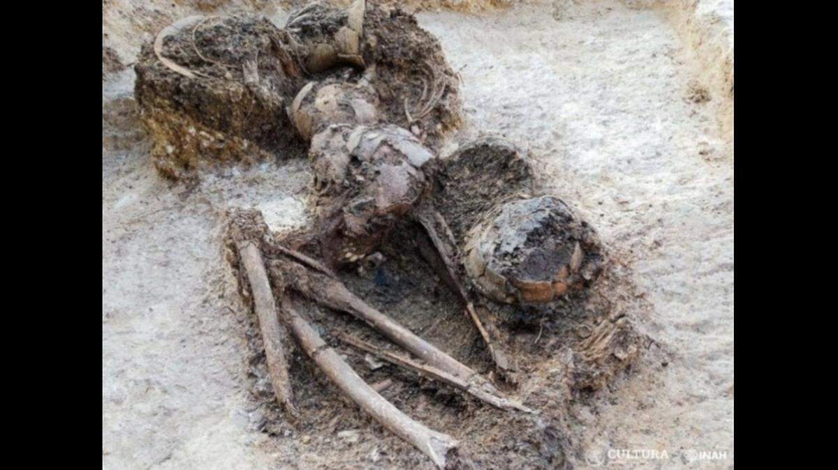 A large grave dating back at least 1,300 years was unearthed near Mexico City, officials said.