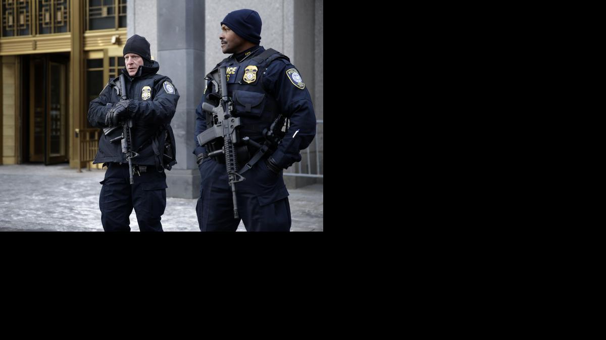 
Security police on Jan. 22, 2015 watch over the entrance to a federal courthouse in New York where the trial of a man charged with conspiring in the 1998 bombings that killed 224 people at two U.S. embassies in Africa is taking place. Fears over the terror attacks in Paris have raised security at the city's federal courthouses to levels not seen since the days following the Sept. 11, 2001, attacks. 
