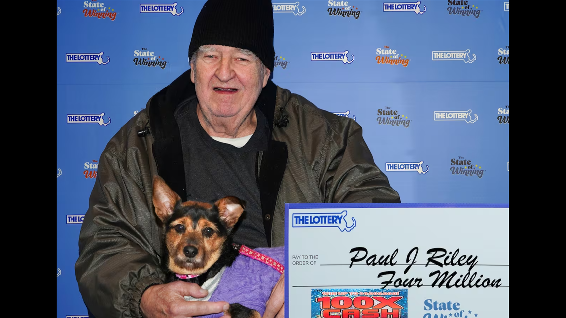 Paul Riley claimed his massive Massachusetts lottery prize with his dog named Raven in tow, officials said.