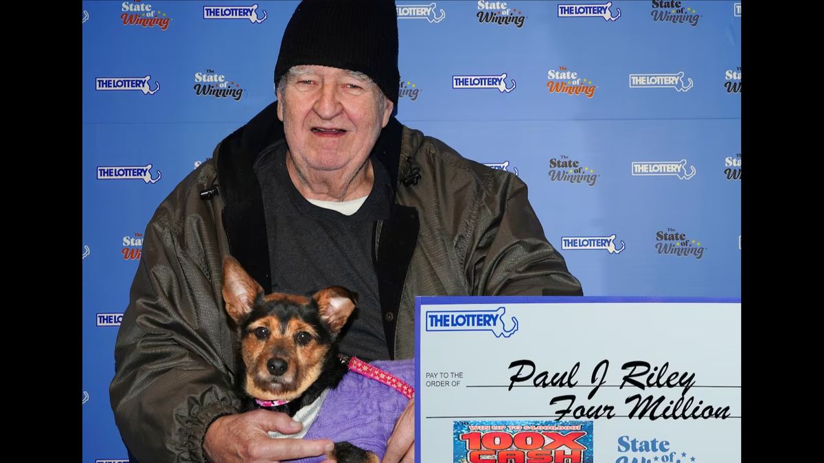 Paul Riley claimed his massive Massachusetts lottery prize with his dog named Raven in tow, officials said.