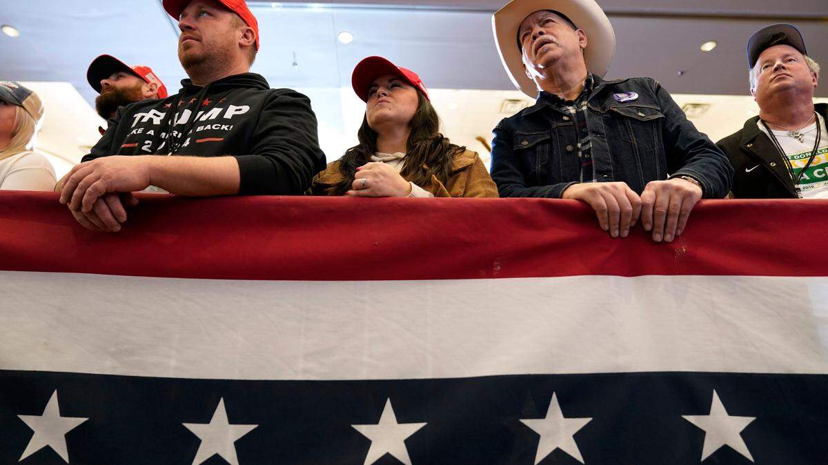 Audience members listen to former President Donald Trump speak during a commit to caucus rally, Wednesday, Dec. 13, 2023, in Coralville, Iowa. (AP Photo/Charlie Neibergall, File)