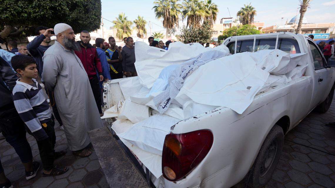 Palestinians look at the bodies of people killed in the Israeli bombardment of the Gaza Strip in front of the morgue of al Aqsa Hospital in Deir al Balah, Gaza Strip, on Tuesday, Nov. 14, 2023. (AP Photo/Adel Hana)