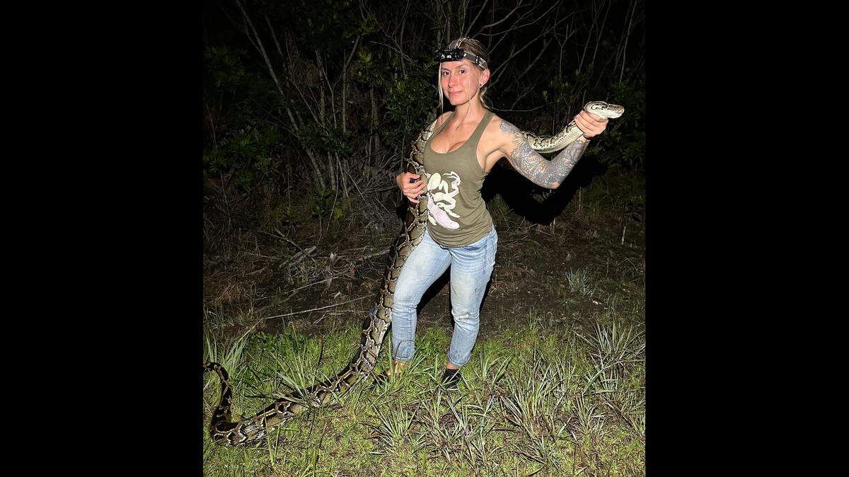 Taylor Stanberry of Naples took home first place in the 2025 Florida Python Challenge. She catches invasive Burmese pythons year-round as a contractor with the Florida Fish and Wildlife Conservation Commission. This photo was not taken during the 10-day challenge.