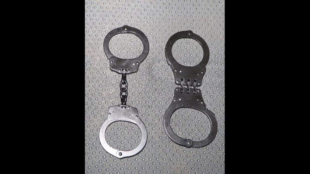 The search of a vehicle belonging to a New York man revealed a fake police badge and handcuffs linking him to two armed robberies in Florida, investigators said.