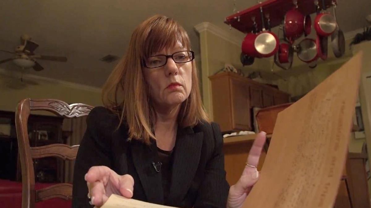 Debbie Wesson Gibson looks through a scrapbook from her senior year in high school, where several pages include what she says is evidence of her relationship with Roy Moore when she was 17 and he was 34.