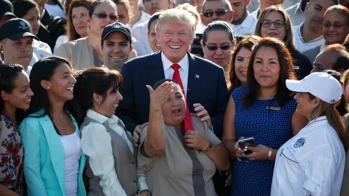 Republican presidential candidate Donald Trump poses for photographs during a campaign event with employees at Trump National Doral Miami on Tuesday, Oct. 25, 2016.
