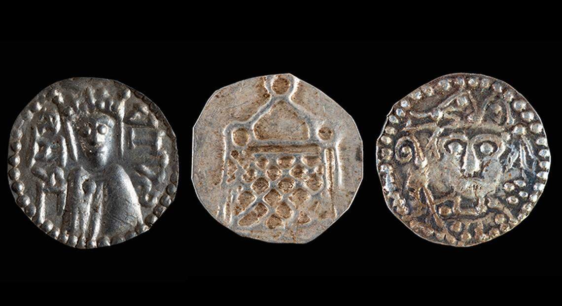 Three coins from the collection found in Stockholm County, including (from left to right) one with the text “KANUTUS,” one with a church-like building and a bishop’s coin.