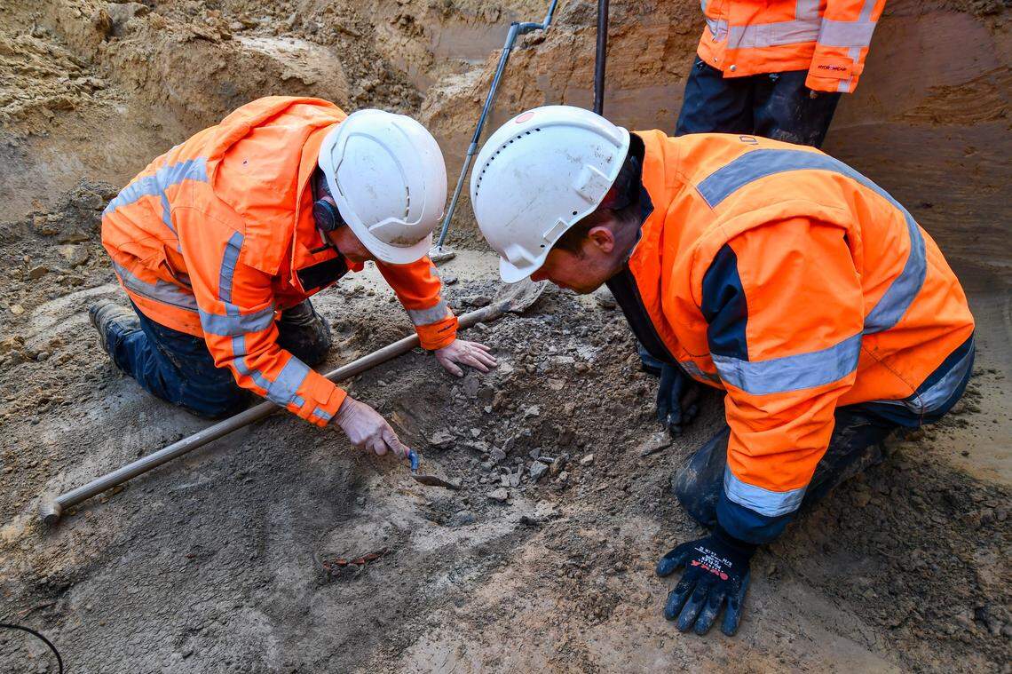 Archaeologists excavate the ancient Roman tomb.