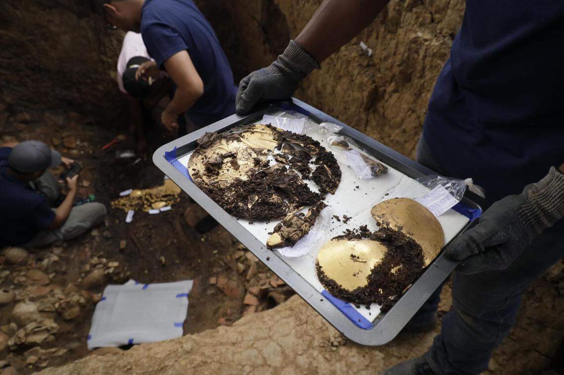 Several gold artifacts from the 1,200-year-old burial sit on a tray.