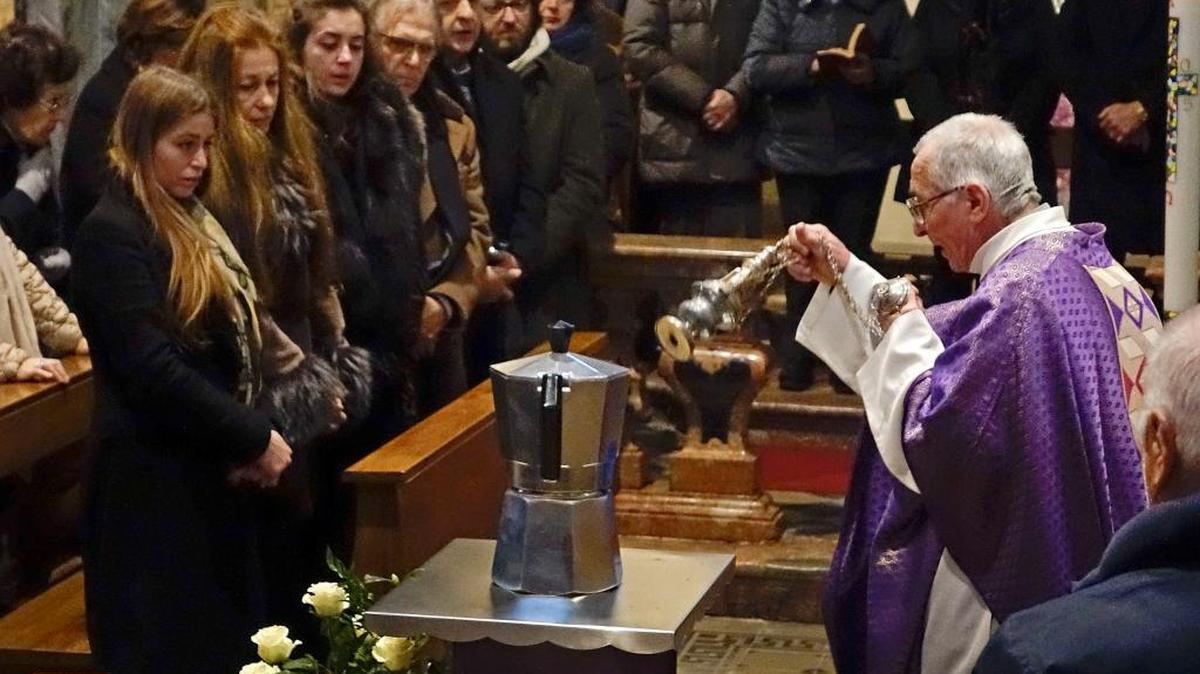Father Pietro Segato, parish priest of Casale Corte Cerro, dispenses incense in front of a coffee pot containing the ashes of Renato Bialetti during his burial service in the church of Casale Corte Cerro, Northern Italy, Tuesday, Feb. 16, 2016.
