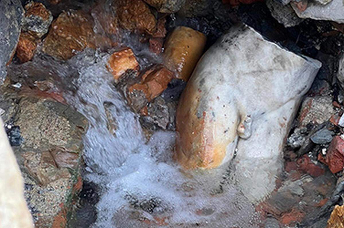 A fragment of the statue still partially submerged.