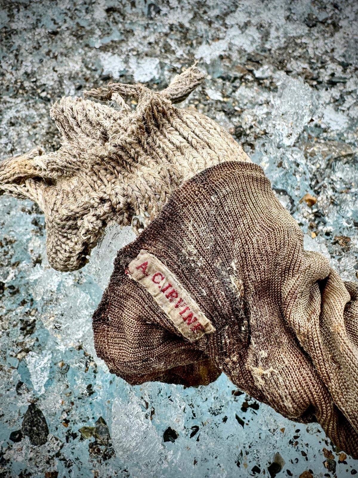A close-up photo shows the name “A.C. Irvine” embroidered on the sock.