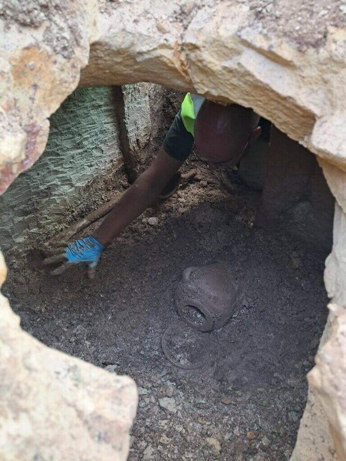 An archaeologist reaches inside the 2,300-year-old tomb.