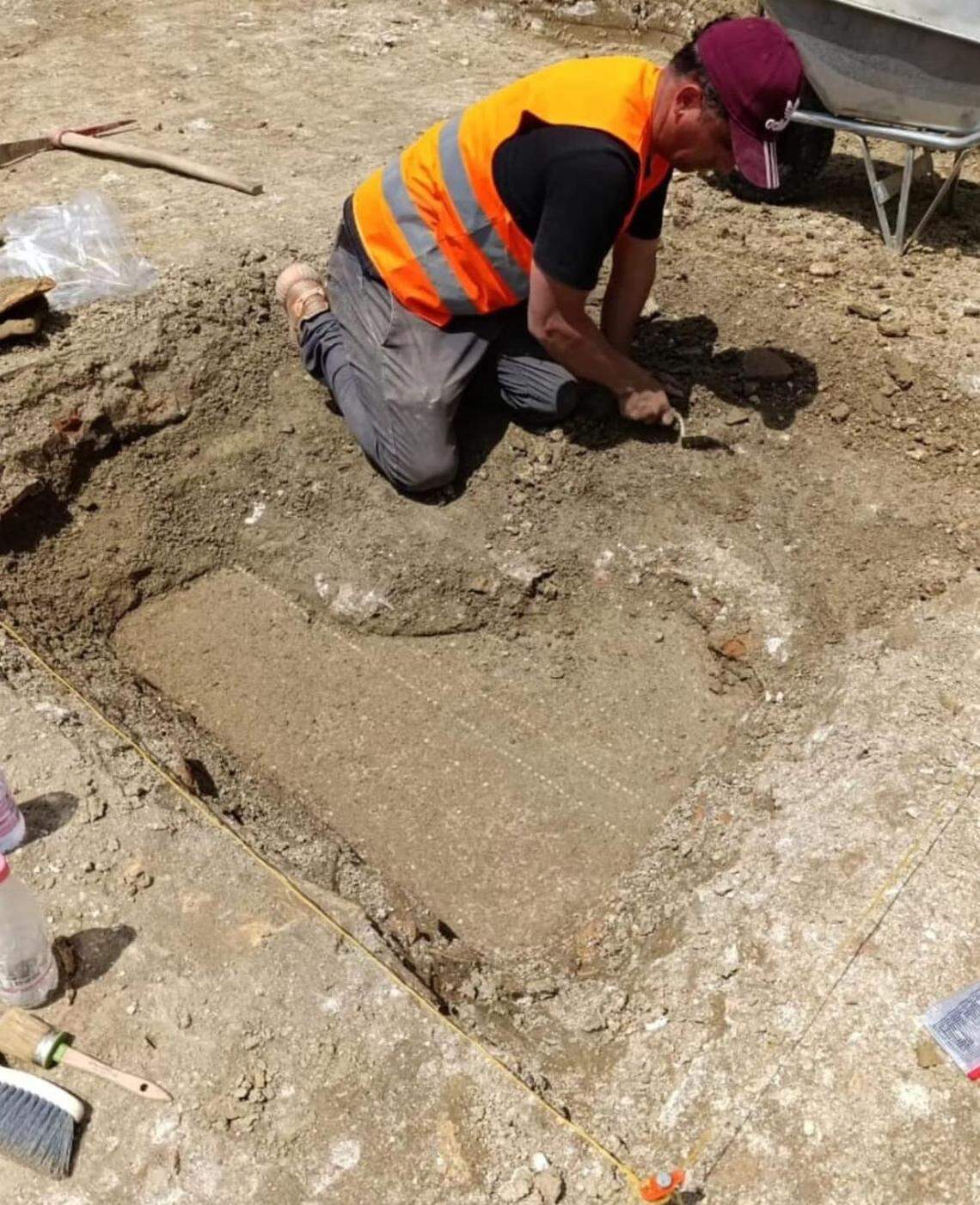 An archaeologist excavates a 1,600-year-old indoor pool at an ancient Roman villa in Durrës.
