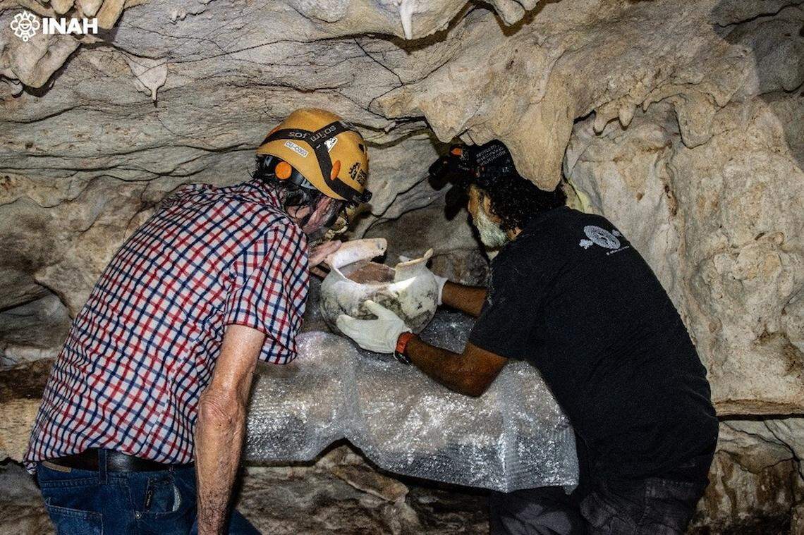 The globular pot was found on a section of the cave wall carved out like a shelf, experts said.