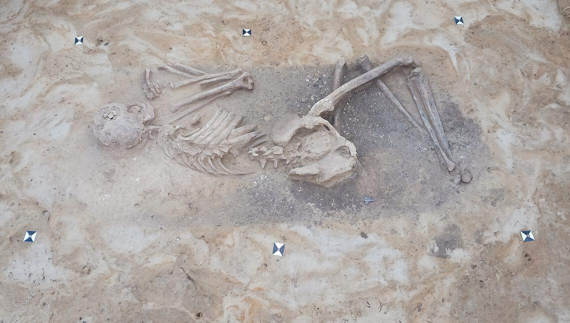 The burial of an ancient warrior with arrowheads and possibly a quiver.