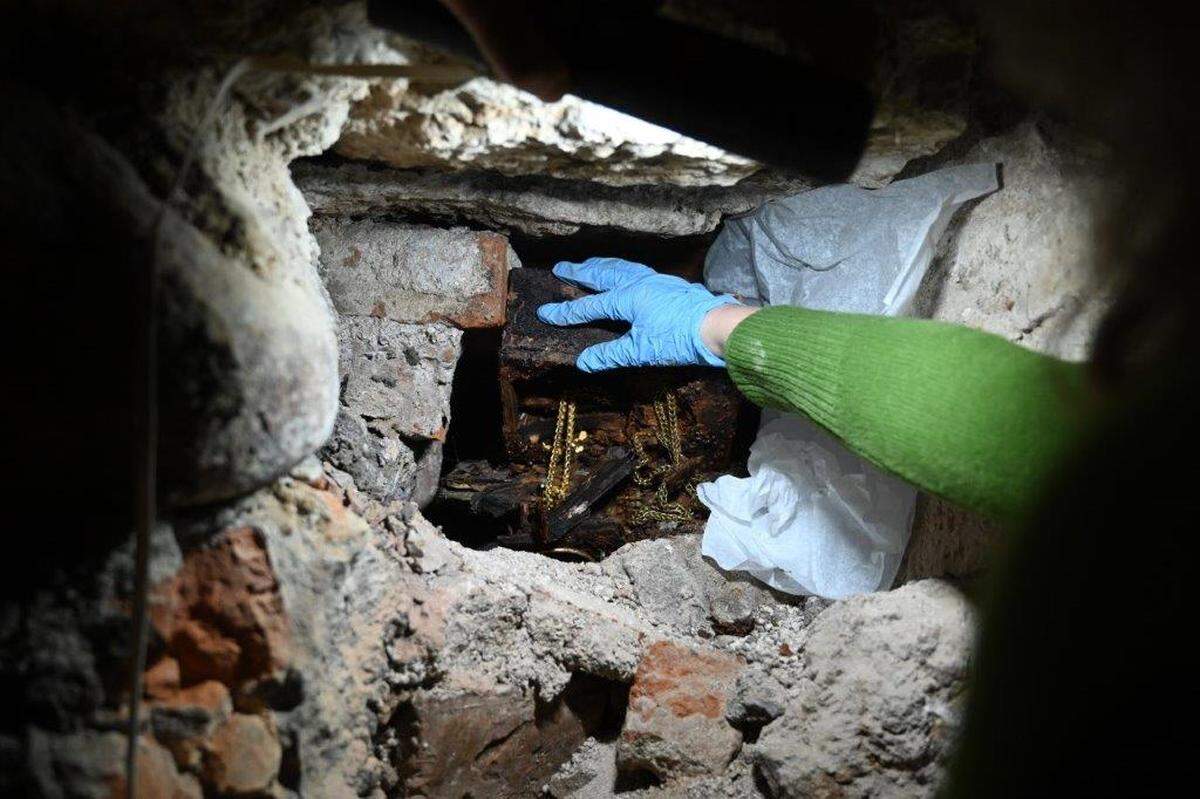 The royal treasures being removed from their hiding spot.