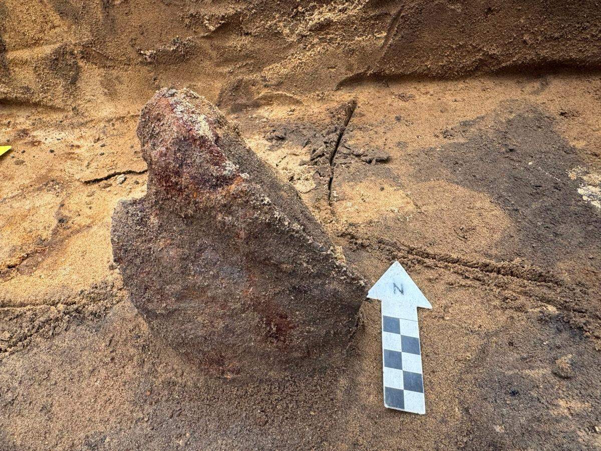 An ancient Roman helmet fragment as seen during excavation.