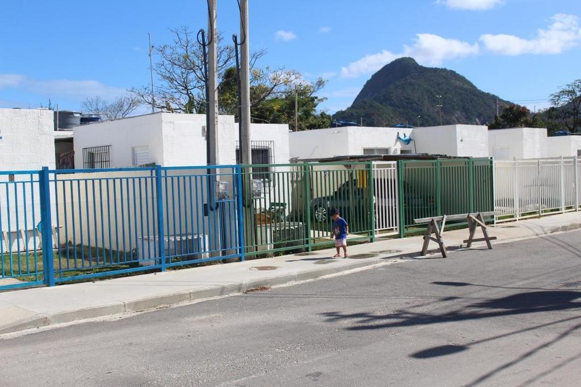 Some neighbors along the single street of the new Vila Autódromo neighborhood have begun to customize their small white homes by painting the fences.