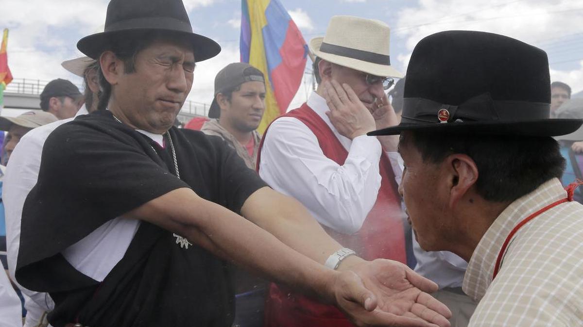 
A shaman spits a liquid on indigenous leader Salvador Quishe to cleanse him in Machachi, Ecuador, Tuesday, Aug. 11, 2015, before the group travels (AP Photo/Dolores Ochoa)
