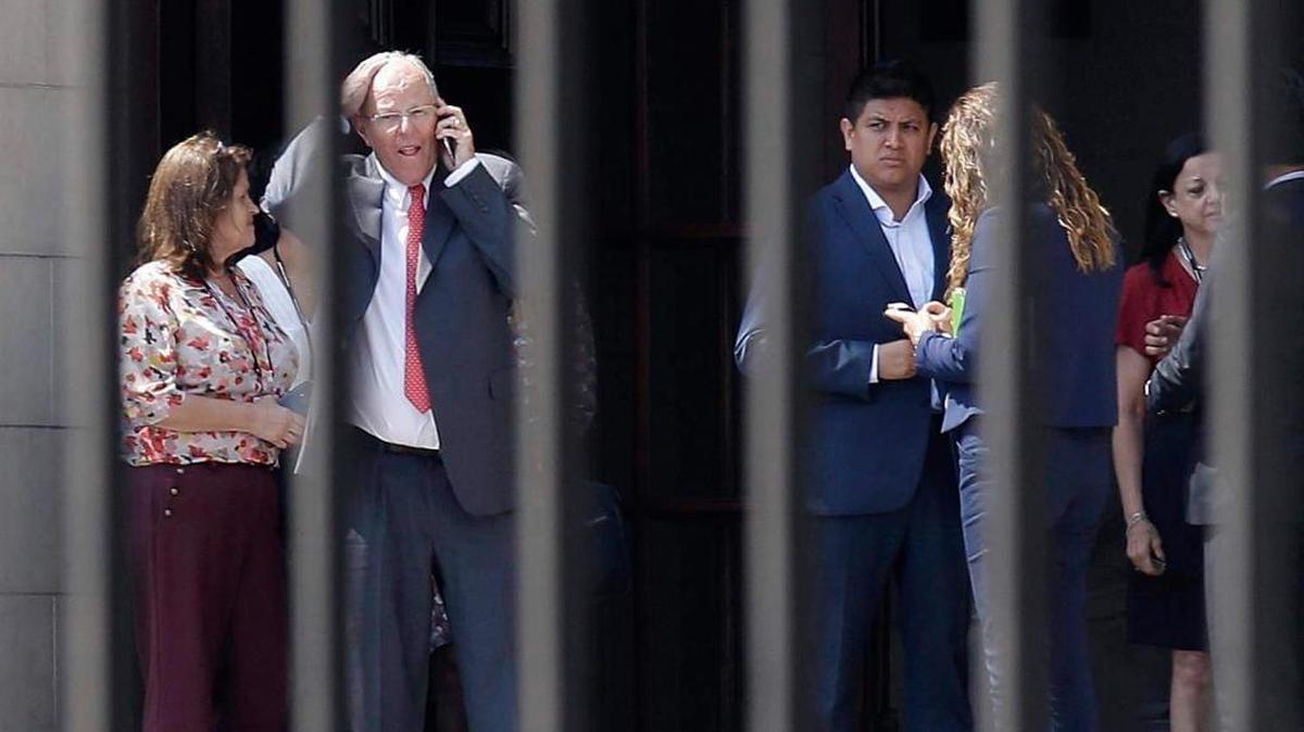 Peru’s President Pedro Pablo Kuczynski talks on his cellphone as he vacates the Government Palace in Lima on Wednesday.