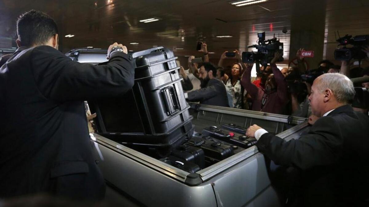 In this Oct. 21, 2016 file photo, federal police put items seized from the Federal Senate Legislative Police headquarters into a vehicle as part of the Operation Car Wash investigation. The Attorney General’s office decided in July to triple its 2018 budget dedicated to the corruption probe engulfing political and business leaders in Brazil and across Latin America.
