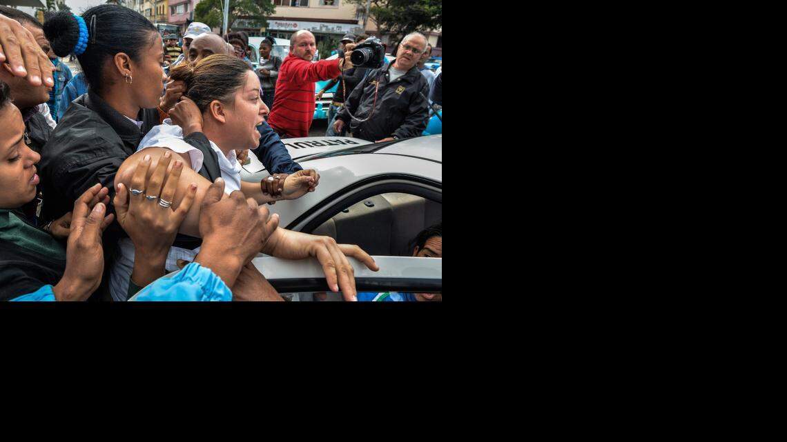 
A member of the Ladies in White opposition movement is arrested during a demonstration to commemorate the Human Rights Day in downtown Havana, on December 10, 2014. 
