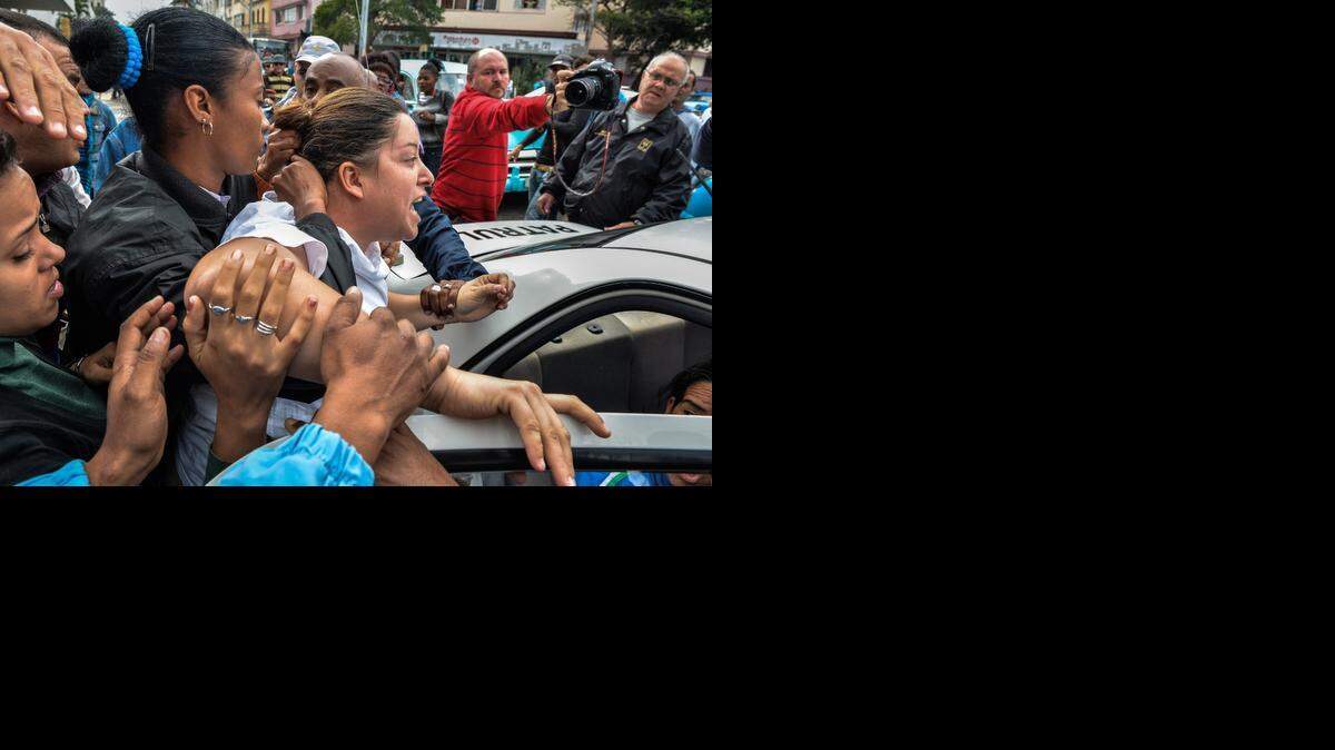 
A member of the Ladies in White opposition movement is arrested during a demonstration to commemorate the Human Rights Day in downtown Havana, on December 10, 2014. 
