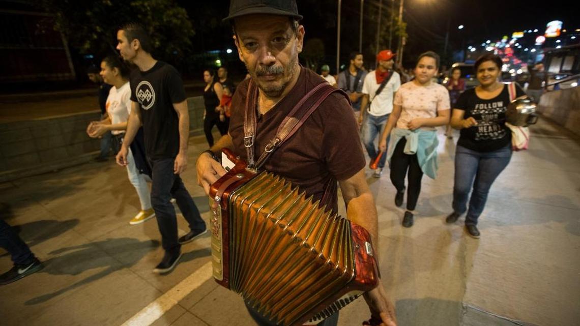 A musician plays an accordion marching during an Anti-government protest in Tegucigalpa, Honduras on Friday.