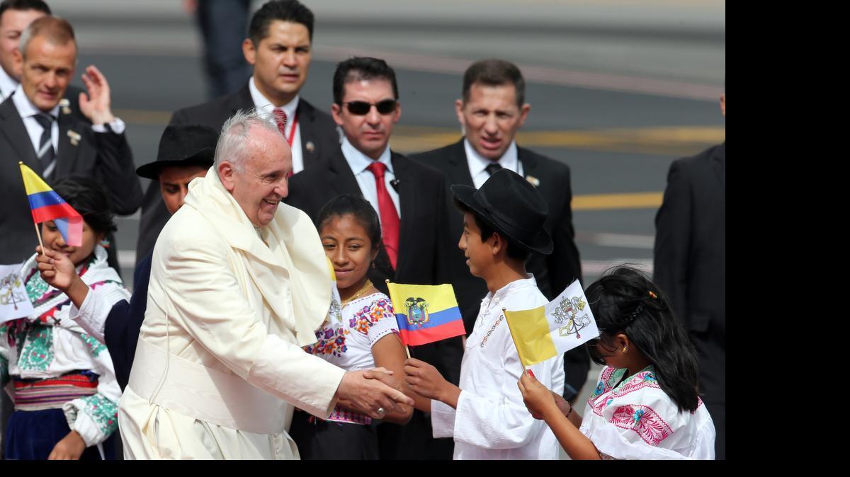 
Pope Francis greets several children upon his arrival to the Mariscal Sucre International airport in Quito Sunday July 5, 2015. History's first Latin American pope returns to Spanish-speaking South America for the first time on Sunday to visit Ecuador, Bolivia and Paraguay.

