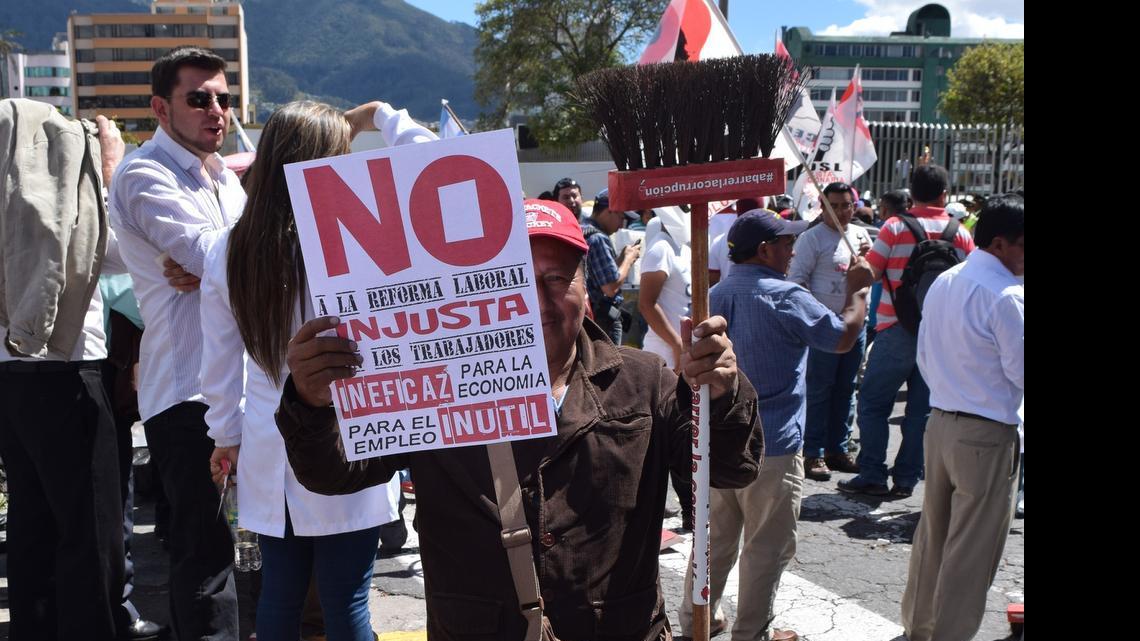 
An anti-government protestor holds up a sign and a broom to “sweep away corruption” in Quito, Ecuador Thursday. As demonstrators prepared for the march, President Rafael Correa called on his supporters to gather in the city center to show support and prevent an alleged coup plot. 
