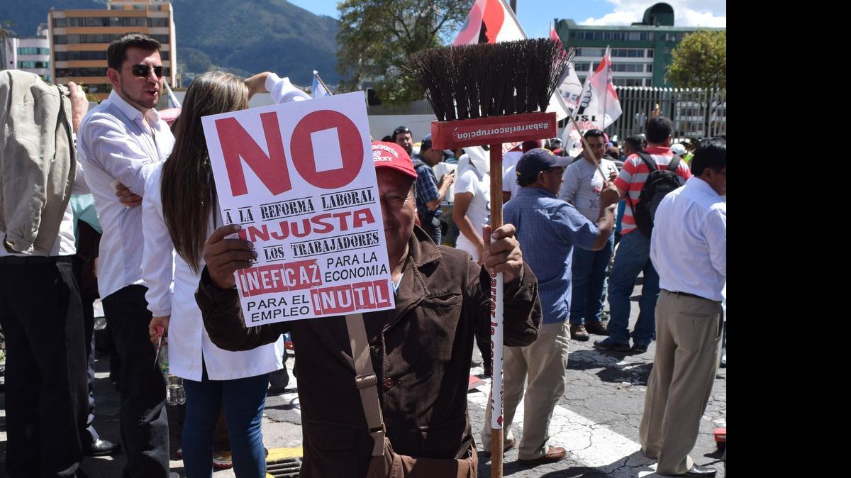 
An anti-government protestor holds up a sign and a broom to “sweep away corruption” in Quito, Ecuador Thursday. As demonstrators prepared for the march, President Rafael Correa called on his supporters to gather in the city center to show support and prevent an alleged coup plot. 
