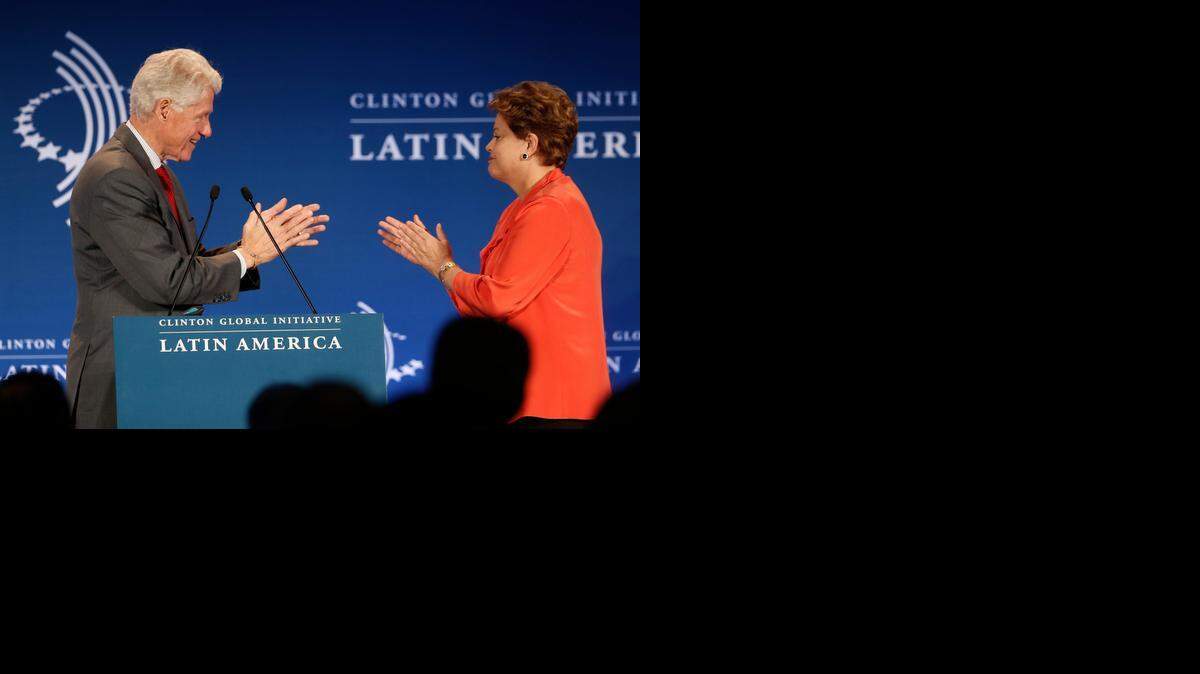 
Former President Bill Clinton, left, and Brazil's President Dilma Rousseff applaud each other at a CGI Clinton Global Initiative Latin America event at the Copacabana Palace in Rio de Janeiro, Brazil, Monday, Dec. 9, 2013. The meeting brought together Latin American leaders to identify, harness, and strengthen ways to improve the livelihoods of people in Latin America and around the world. Clinton is planning a “Future of the Americas” summit on Dec. 11 in Miami. 
