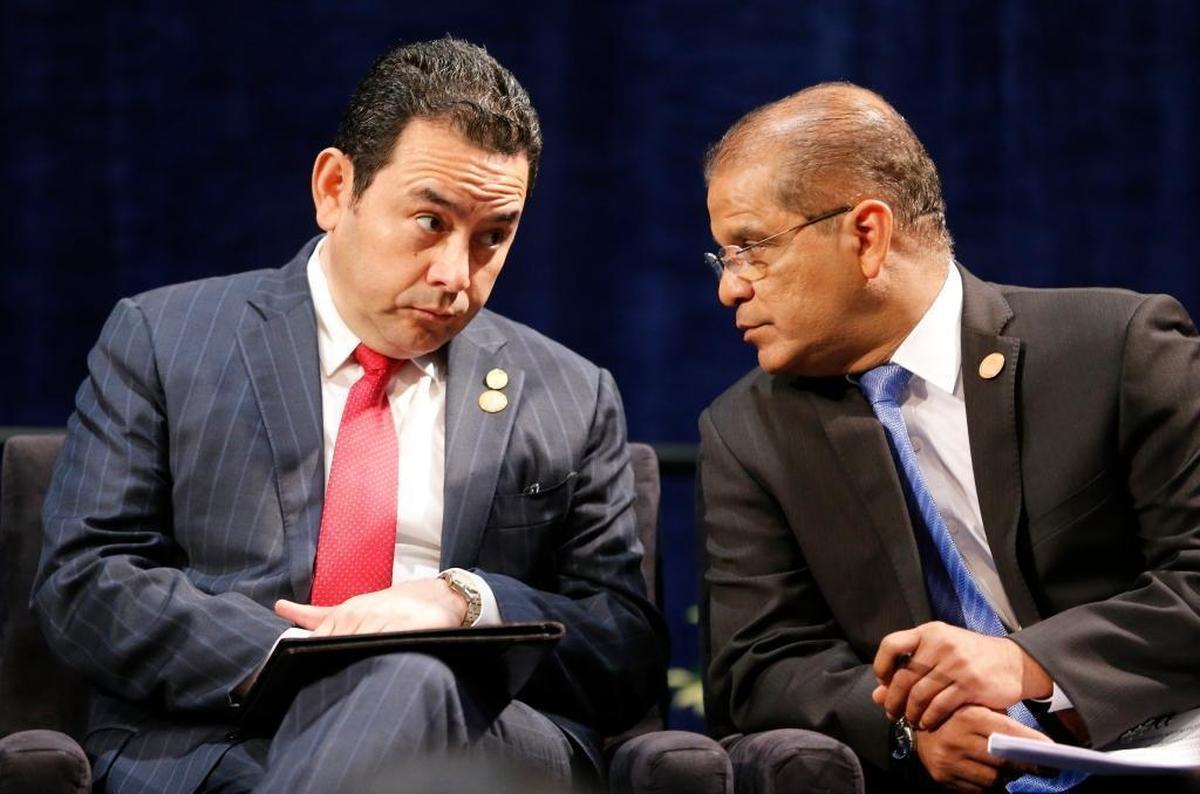 President of Guatemala Jimmy Morales, left, and El Salvador Vice President Oscar Ortiz, right, talk at the opening session of the Conference on Prosperity and Security in Central America at Florida International University on Thursday, June 15, 2017.
