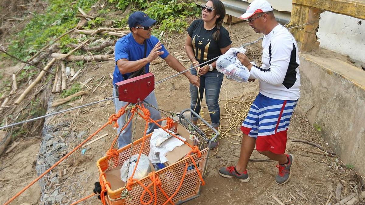 Good Samaritans of the town of Isabela. Brothers Saul Aldarondo, left, and Luis Aldarondo, alongside Mary Lopez, fill a shopping cart with necessities for the Rio Abajo neighborhood of Utuado known now as ‘The Forgotten Ones’ during the aftermath of Hurricane Maria.