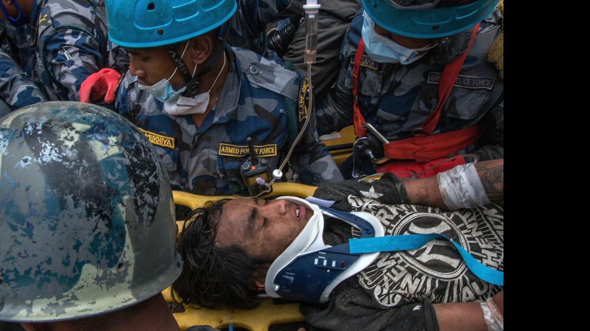 
Nepal army forces in collaboration with members of an American Search and Rescue team rescue 15 year old Pemba Lama from a collapsed hotel five days after the earthquake hit Nepal on April 30, 2015 in Kathmandu, Nepal. 
