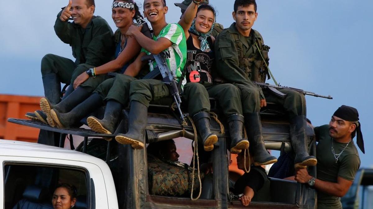 In this Friday, Sept. 16, 2016 photo, rebels of the Revolutionary Armed Forces of Colombia (FARC) arrive in the Yari Plains in southern Colombia. FARC rebels gathered for a congress to discuss and vote on a peace accord reached with the Colombian government to end five decades of war.