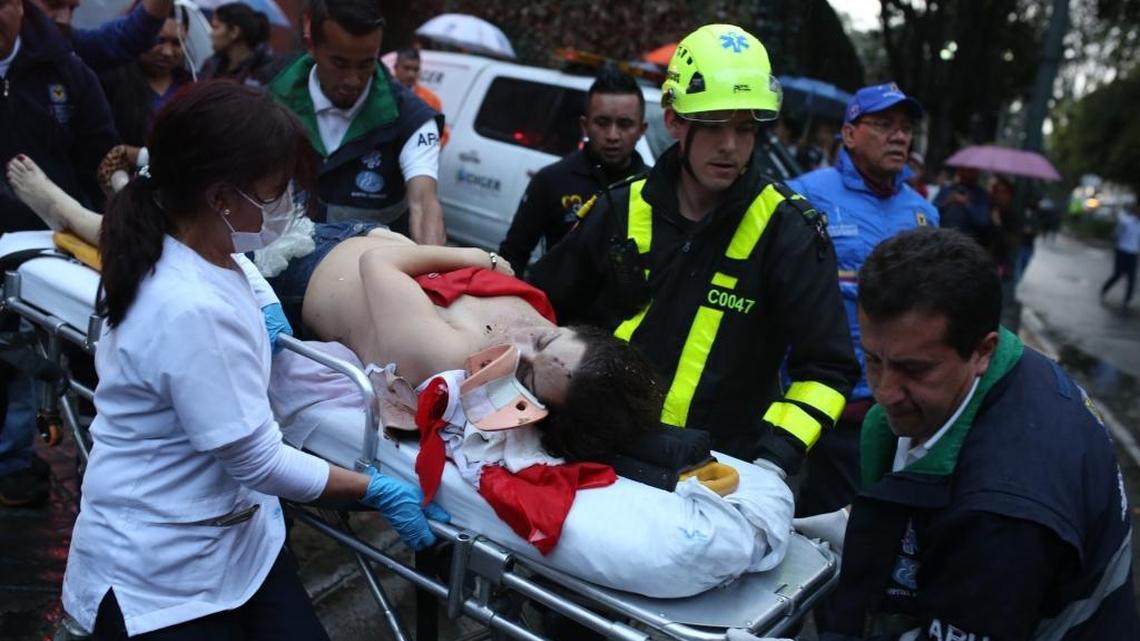 A woman is evacuated on a gurney after an explosion at the Centro Andino shopping center in Bogota, Colombia, Saturday, June 17, 2017.