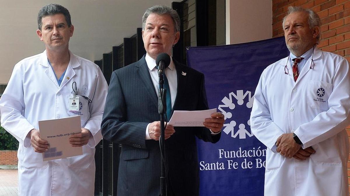 Colombian President Juan Manuel Santos (center) announces on Tuesday that he will be traveling to the United States amid fears that his prostate cancer has returned.