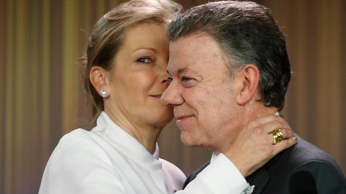 Colombia's President Juan Manuel Santos is embraced by his wife Maria Clemencia Rodriguez after speaking to journalists at the presidential palace in Bogota, Colombia, Friday, Oct. 7, 2016. Santos won the Nobel Peace Prize Friday, just days after voters narrowly rejected a peace deal he signed with rebels of the Revolutionary Armed Forces of Colombia, FARC.