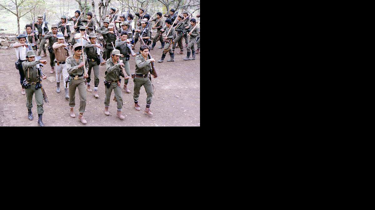 
In this file photo taken in the 1980s, FARC fighters train at a camp somewhere in the Colombian mountainous region. 
