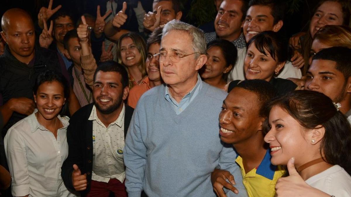 Opposition Senator and former President Alvaro Uribe, third from right front, poses with supporters after reading a statement at his house in Rionegro, Colombia, Sunday, Oct. 2, 2016. Colombians rejected a peace deal with leftist rebels by a razor-thin margin in a national referendum. Opposition to the accord, led by Uribe, argued that the government was appeasing the FARC and setting a bad example by sparing rebels jail time if they confess their crimes and guaranteeing the group 10 seats in congress through 2026.