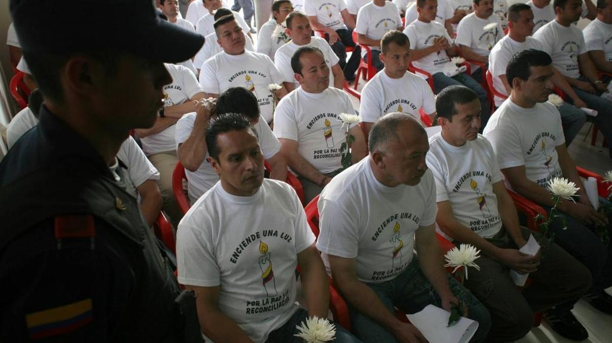 In this March 11, 2009, photo, a group of rebels of the Revolutionary Armed Forces of Colombia attend a ceremony where they graduated as "peacemakers."