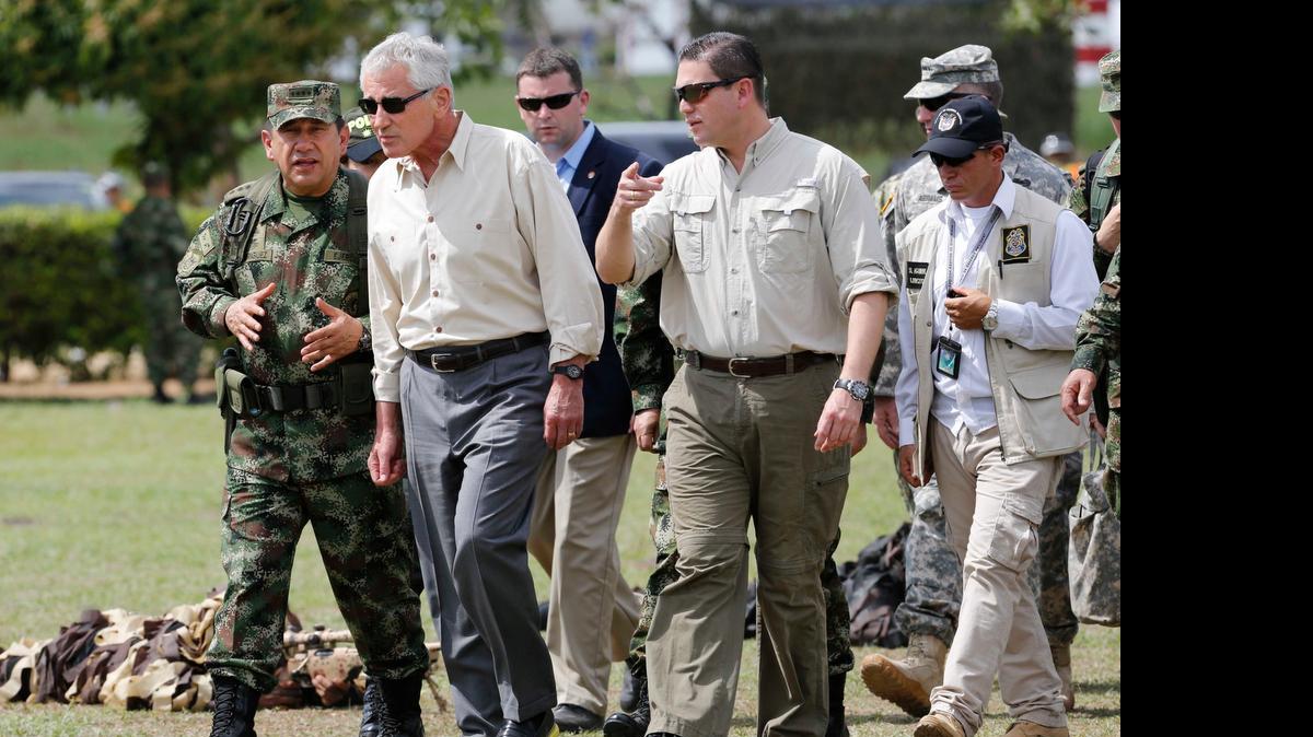 
Colombian Armed Forces Commander, Gen. Juan Pablo Rodriguez, left, and Defense Minister Juan Carlos Pinzon, right, lead a tour for U.S. Defense Secretary Chuck Hagel, center, at the Tolemaida military base, in Melgar, Colombia, Friday, Oct. 10, 2014. Hagel is on a six-day, three-country trip to South America. Hagel will also travel to Chile and Peru, where he will attend a conference of defense ministers from the Americas. 
