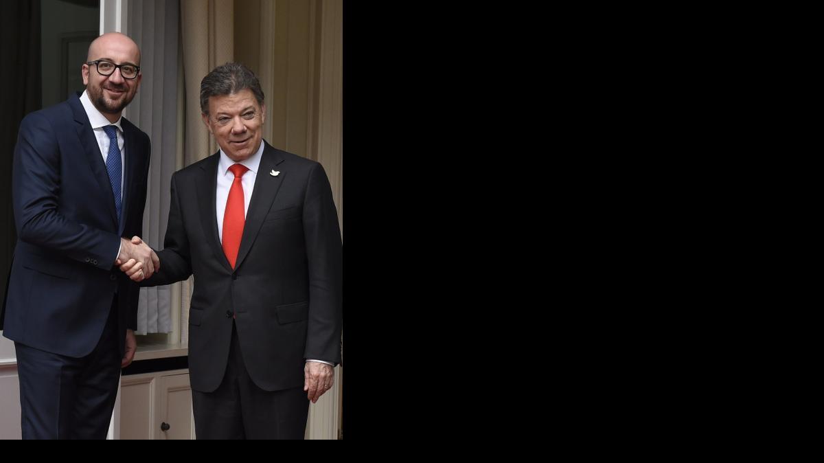 
Belgian Prime Minister Charles Michel (L) shake hands with president of Colombia Juan Manuel Santos Calderón before their bilateral meeting on November 04, 2014 in Brussels. 
